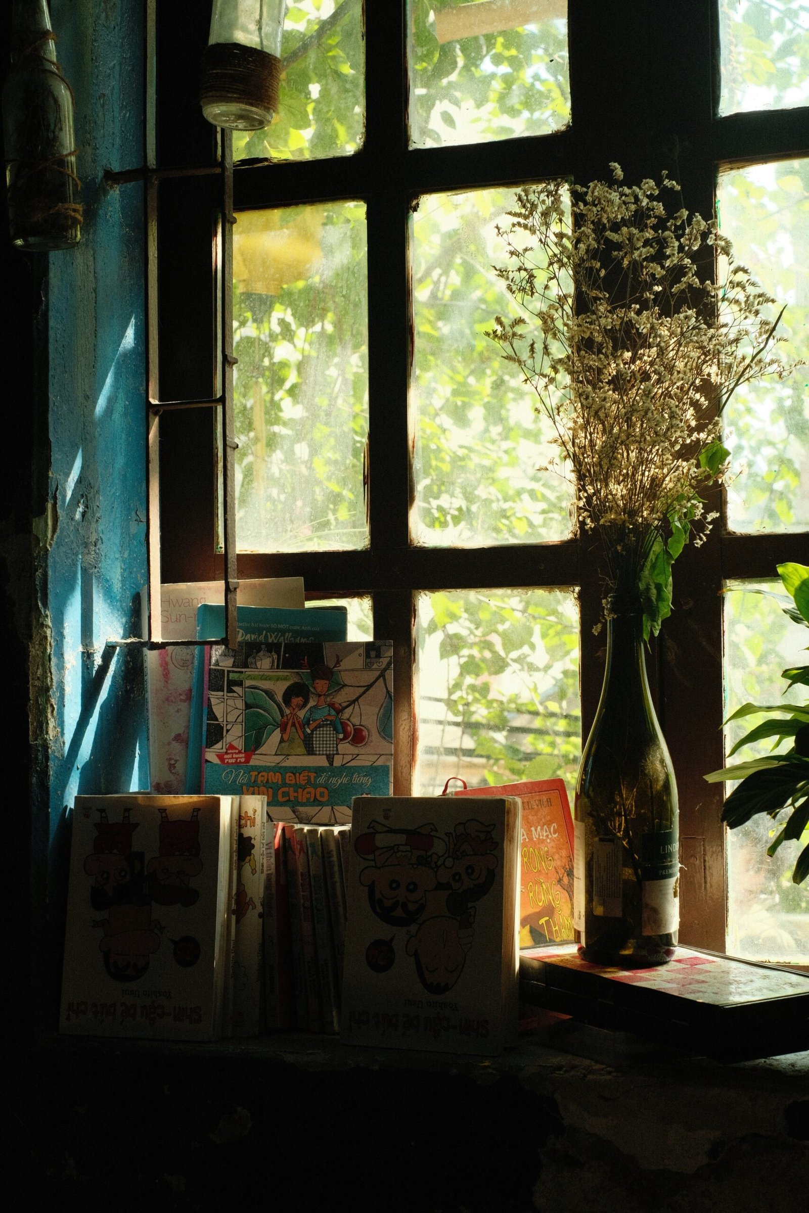 a vase of flowers sitting on a window sill